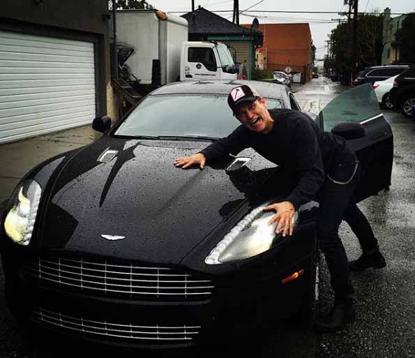 Stephen Moyer taking a picture with car.